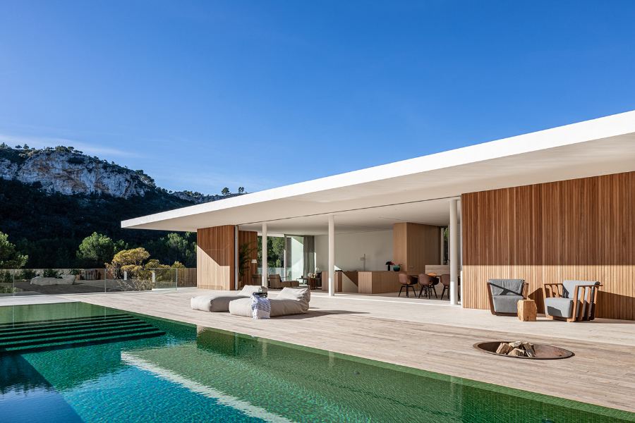 house by Jorge Bibiloni Studio with long pool and outdoor furniture